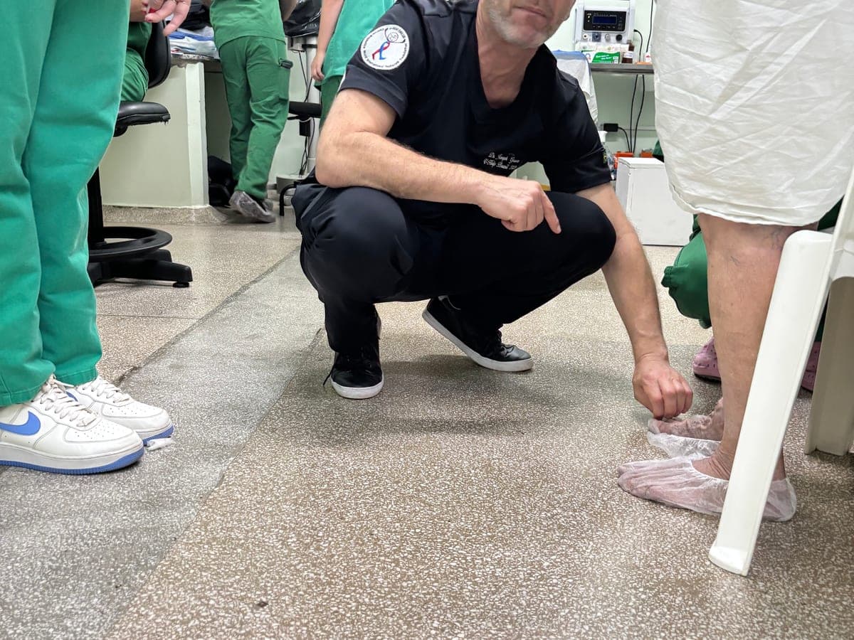 A v-HELP faculty member preparing a patient before treatment in the operating room