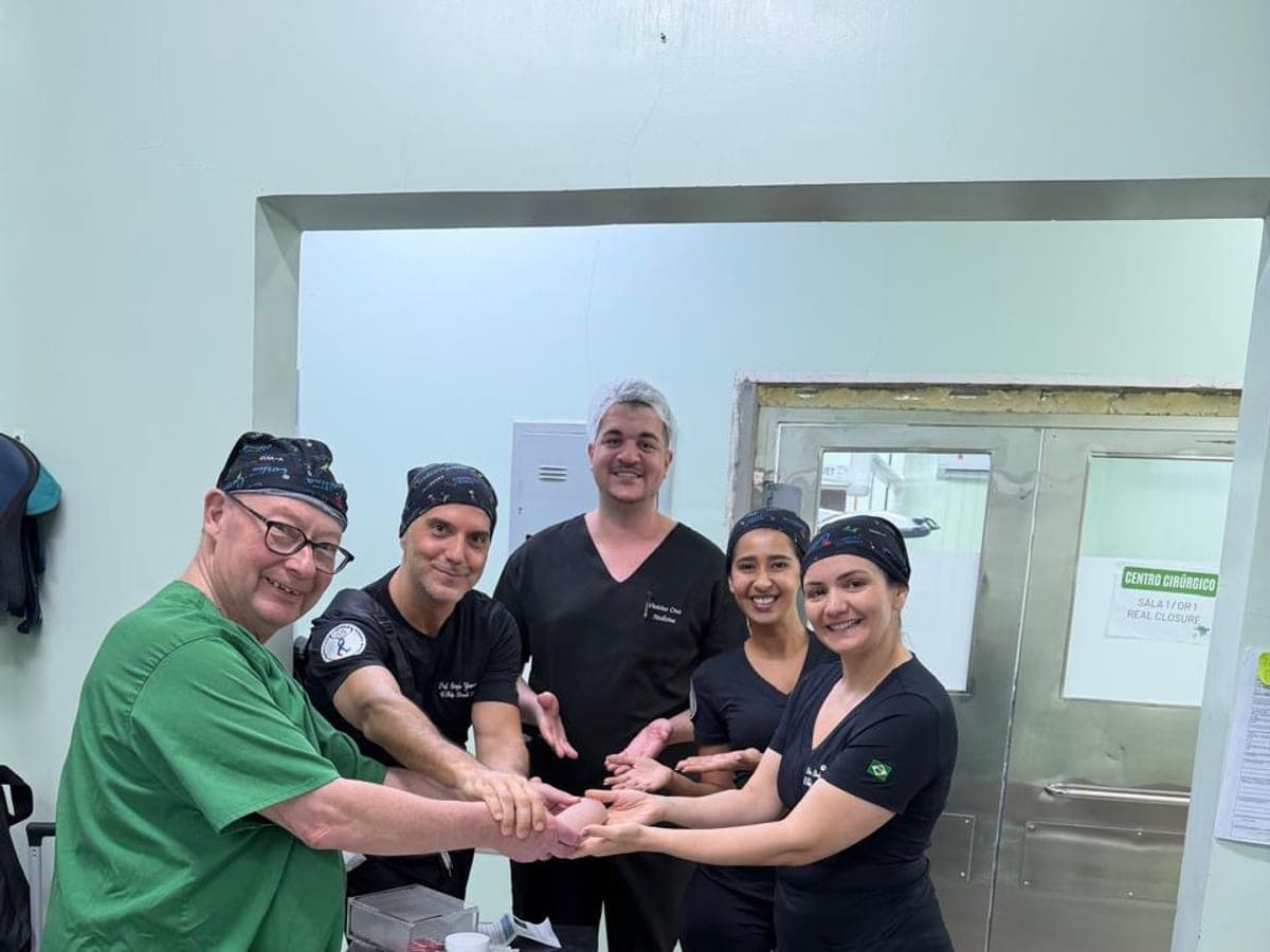 The multidisciplinary team joining hands outside the operating theatre