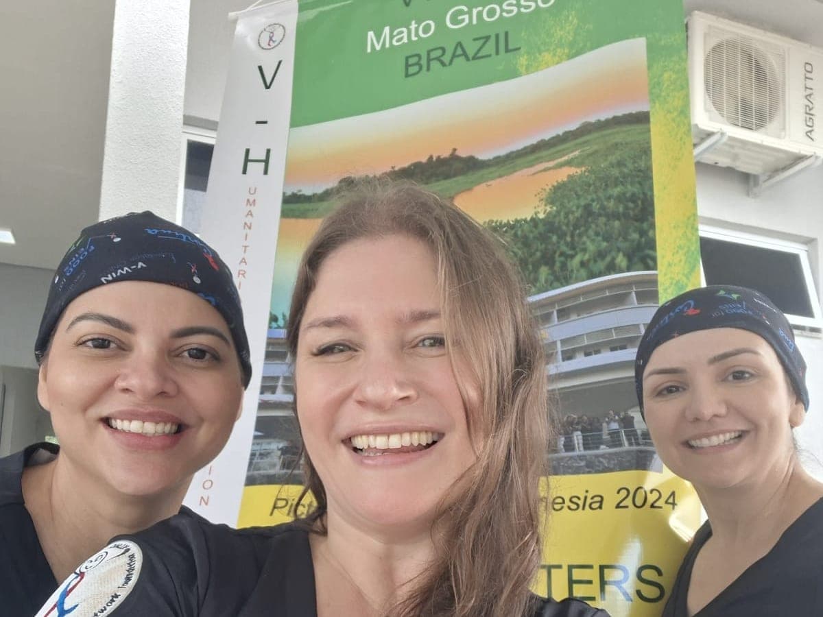 Volunteers in front of the v-HELP humanitarian mission banner in Mato Grosso, Brazil